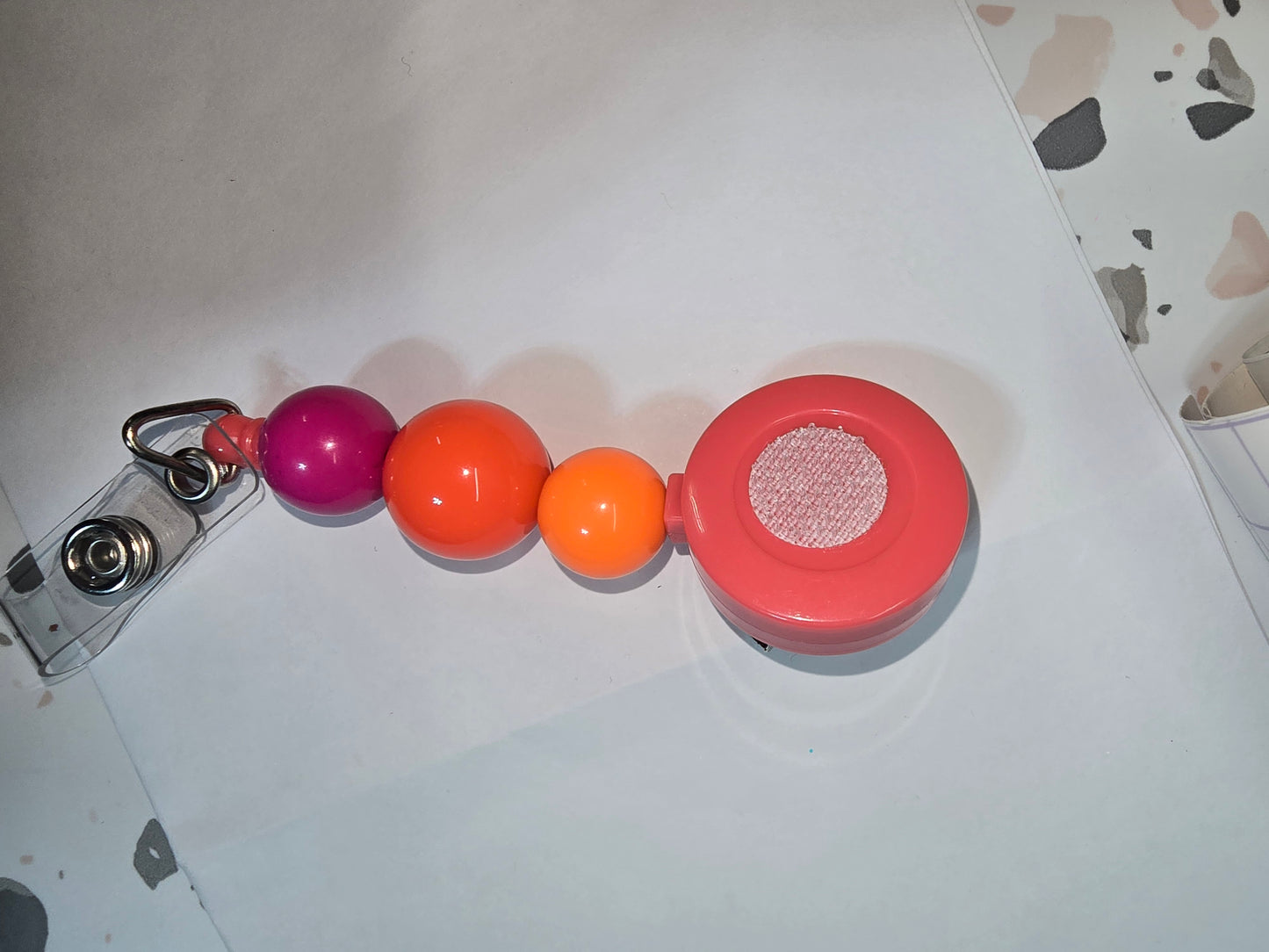 Badge Reel- coral orange and purple